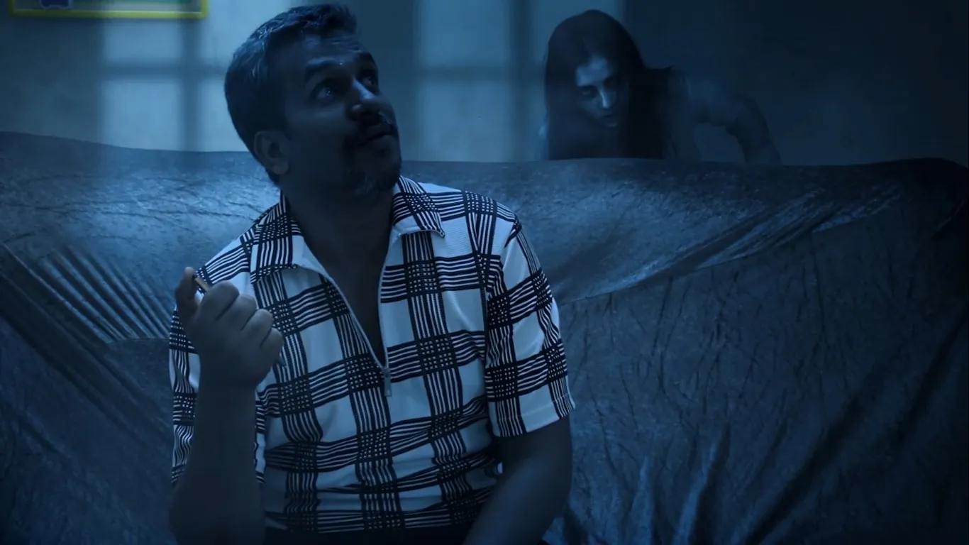 A man looks up while a ghost crawls behind him